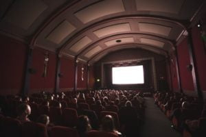 audience in theater looking at screen