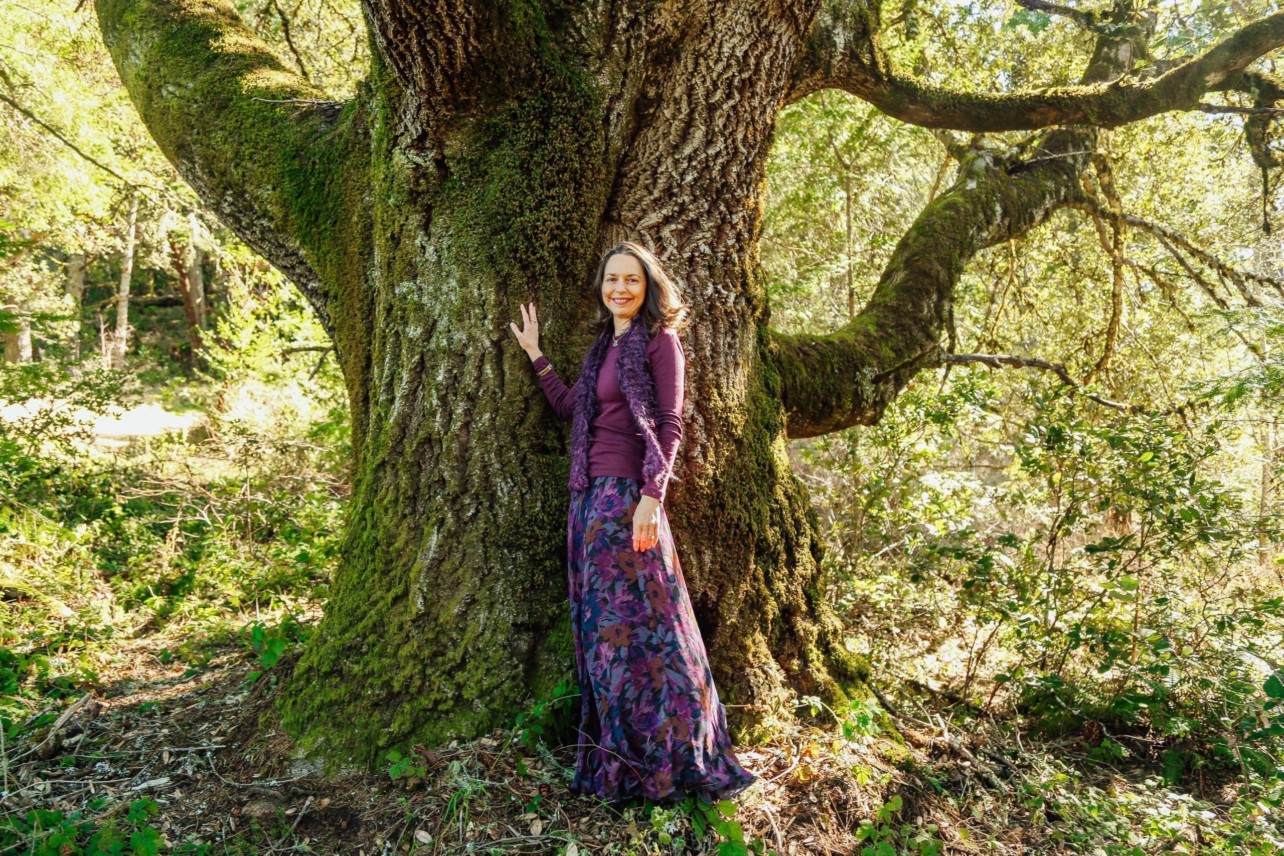 Rev. Connie by a large tree - thriving in challenging times