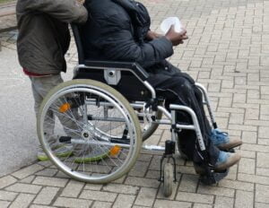 person in wheelchair holding a cup
