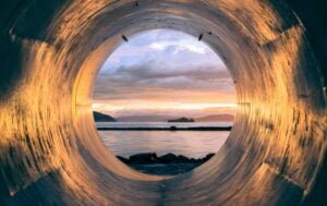 viewing the ocean through a steel tunnel full of light