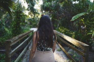 woman stepping first onto a bridge
