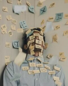 man struggling with styana with sticky notes all over him