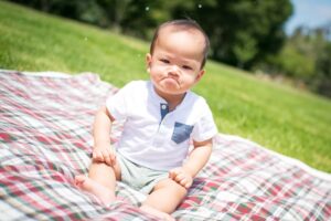 baby on a blanket with the grumpies