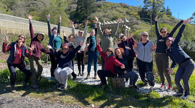 Group photo of Spring 2023 participants smiling and waving