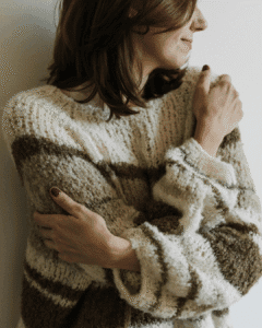 Woman embracing herself, smiling and showing wholeness and self-acceptance